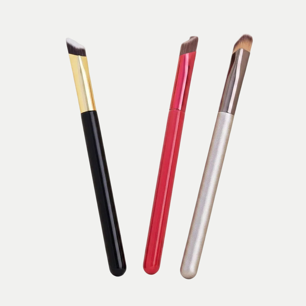 MEDAIONE angled eyebrow brushes with black, red, and champagne handles. Soft nylon bristles for precise makeup application.