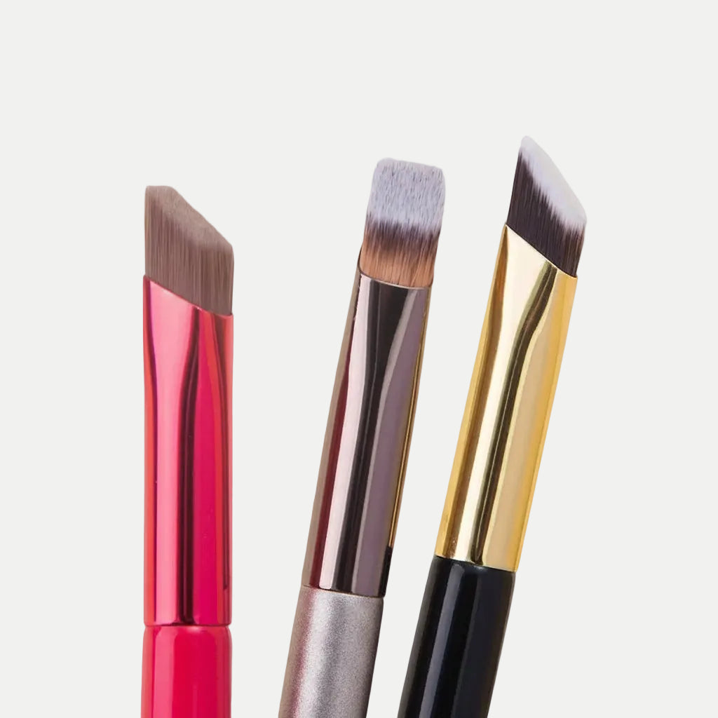 MEDAIONE angled eyebrow brushes with nylon bristles and metallic handles in pink, champagne, and black.