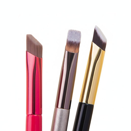 MEDAIONE angled eyebrow brushes with nylon bristles and metallic handles in pink, champagne, and black.